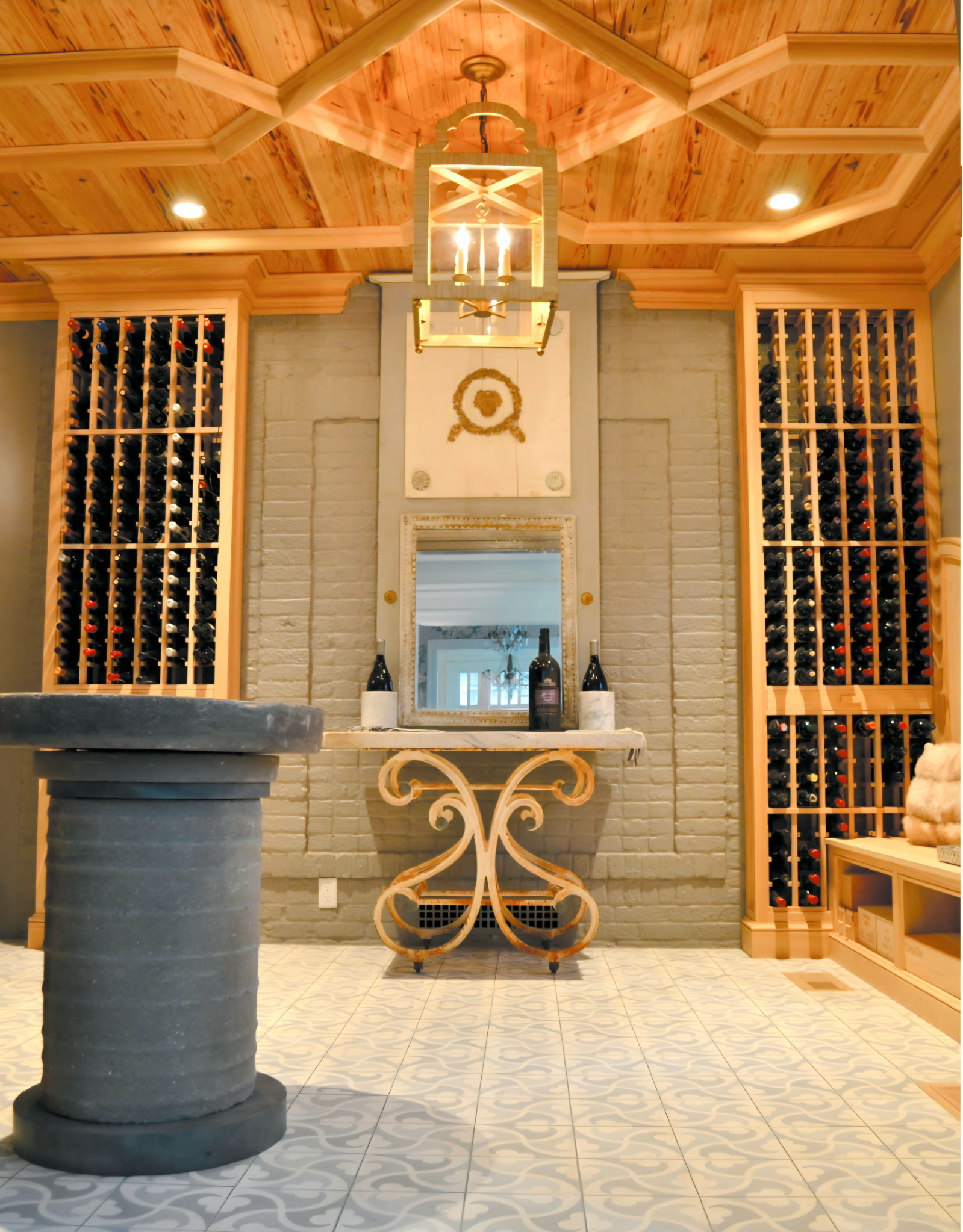 Wine cellar with a cypress ceiling, antique stone wellhead, and wrought-iron console — Belle Meade, Nashville