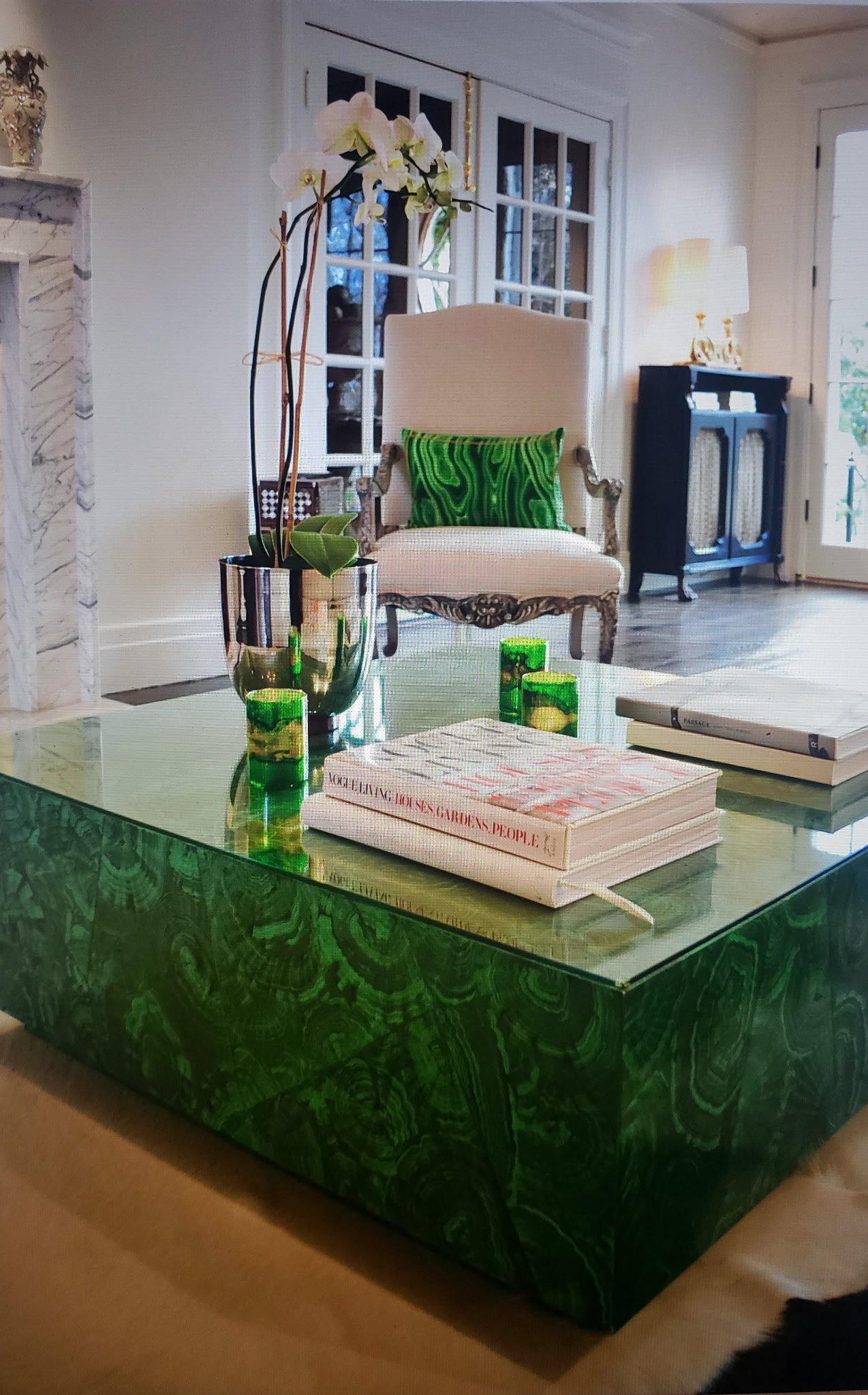 Living room styled around a malachite-veneered coffee table with orchids and collectible books — Belle Meade, Nashville