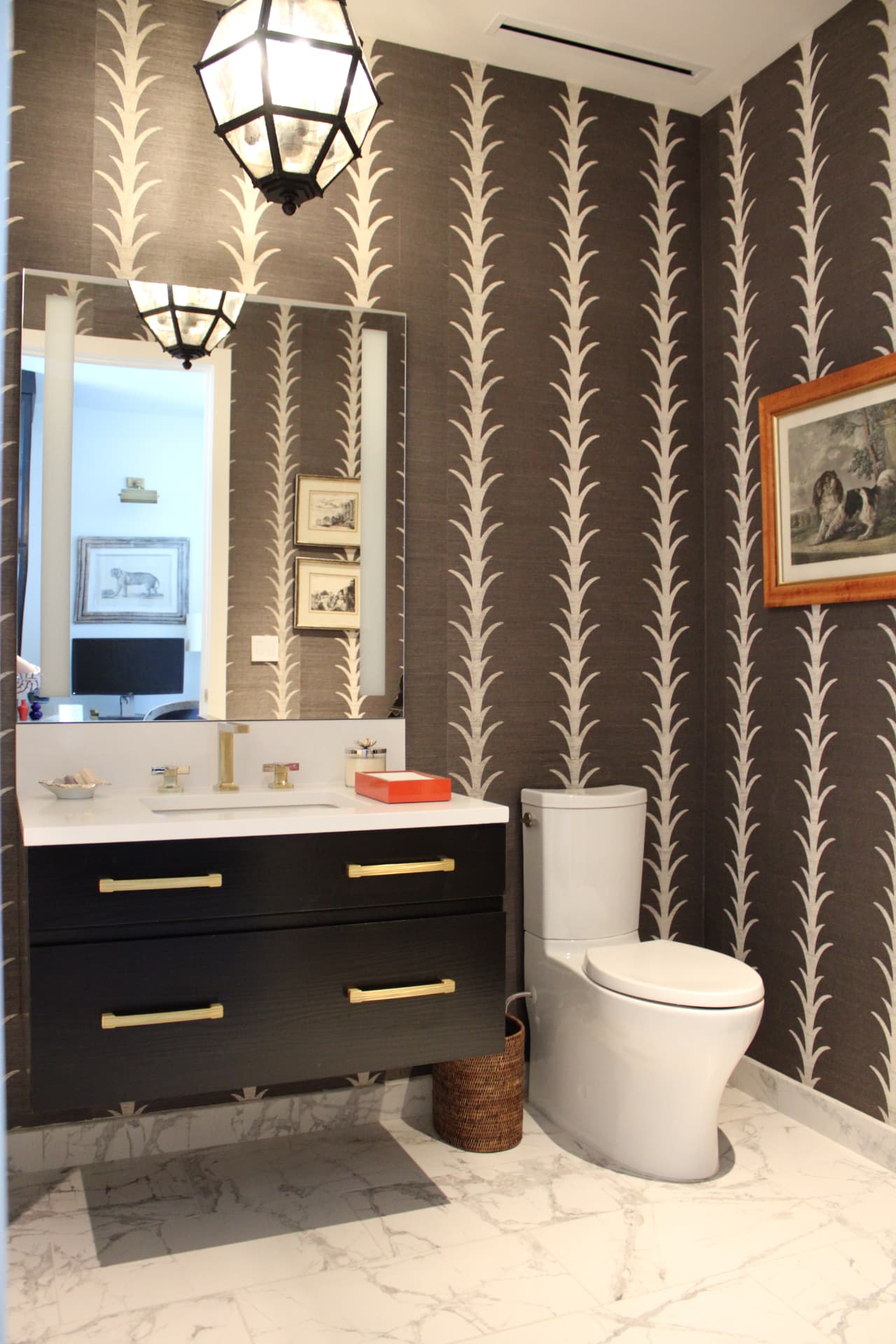 Powder room with dark palm-frond wallpaper, a black floating vanity, and brass lantern pendant — Downtown Nashville, Nashville